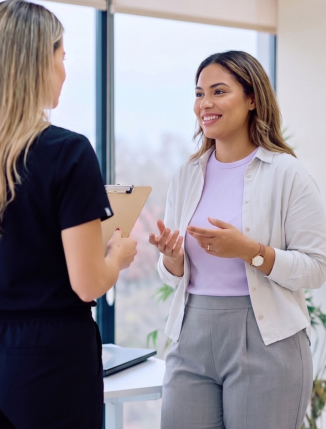 Two women having a conversation in an office.