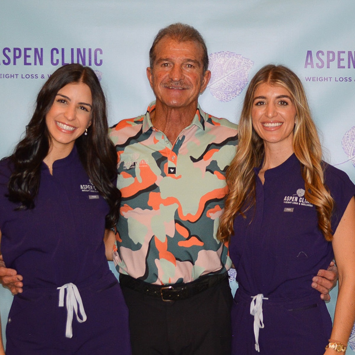 Three professionals at Aspen Clinic event.
