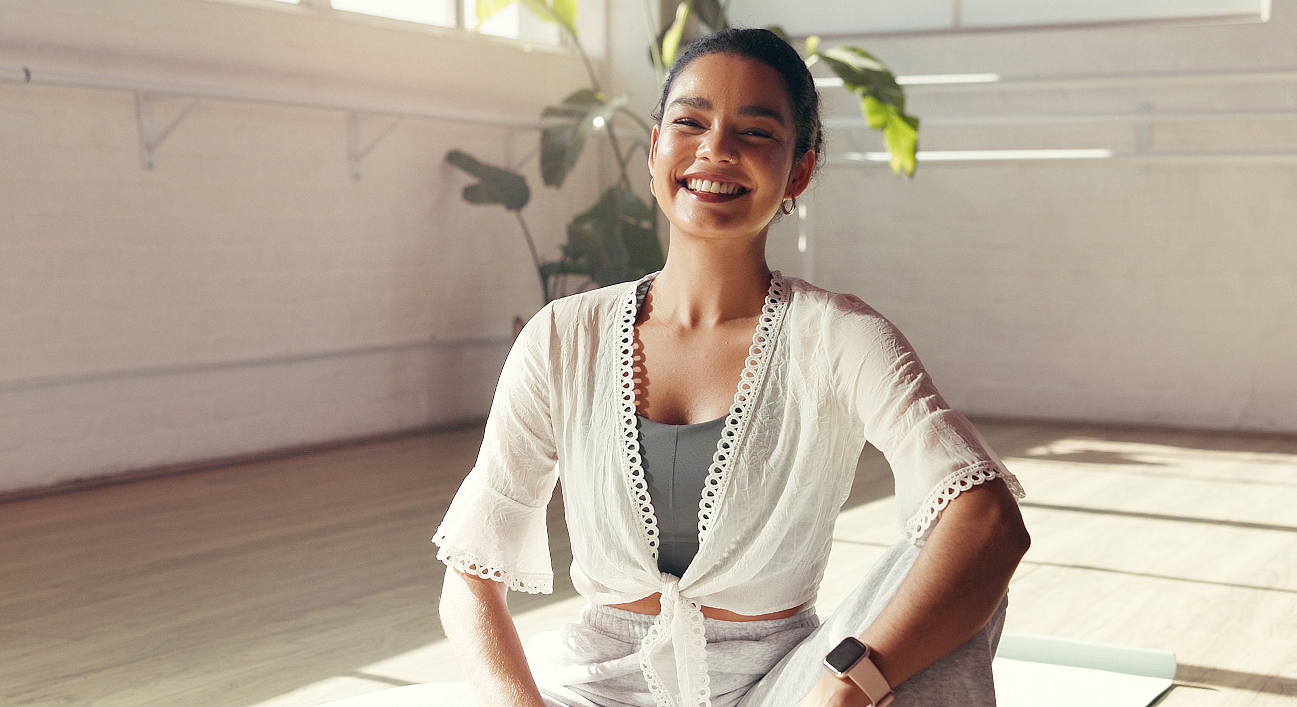 Smiling woman in a bright fitness studio.