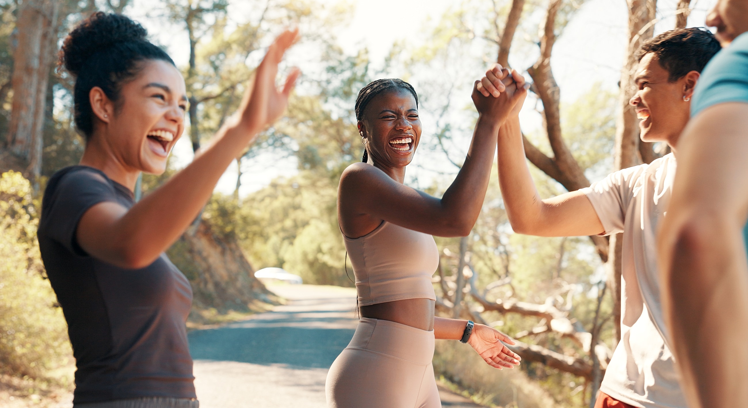 Friends celebrating and supporting each other outdoors.