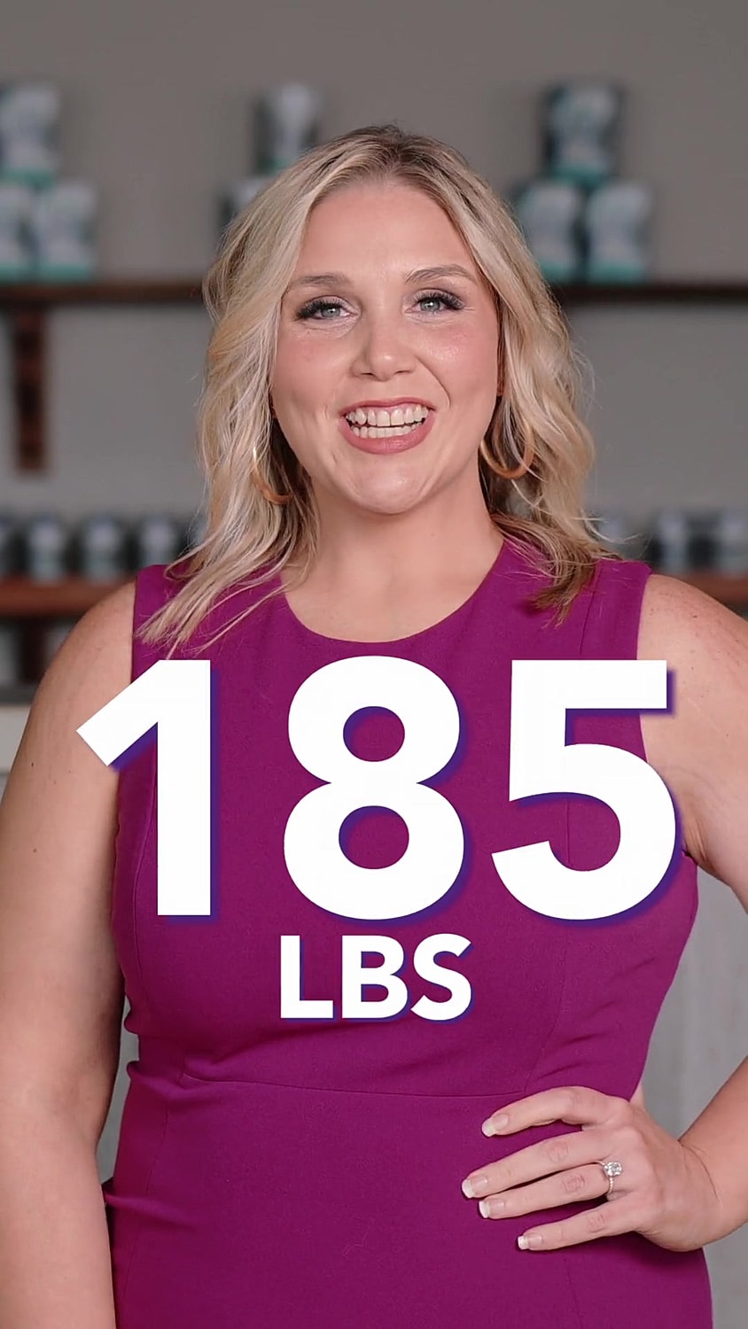 Woman smiling in pink dress, weighing 185 lbs.