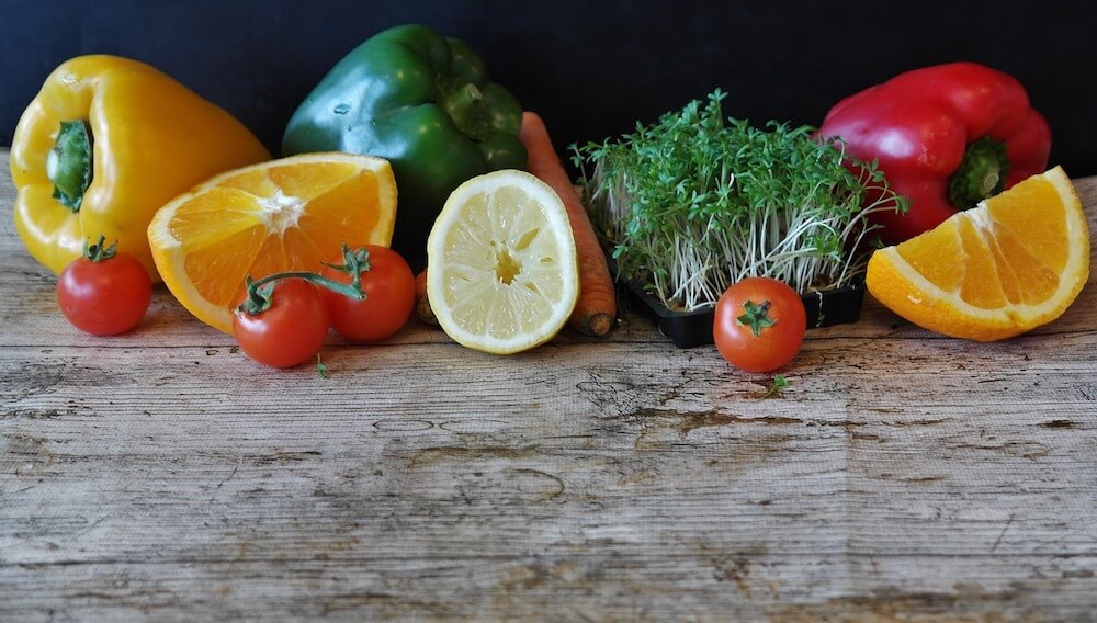 Healthy fruits and vegetables on wooden table