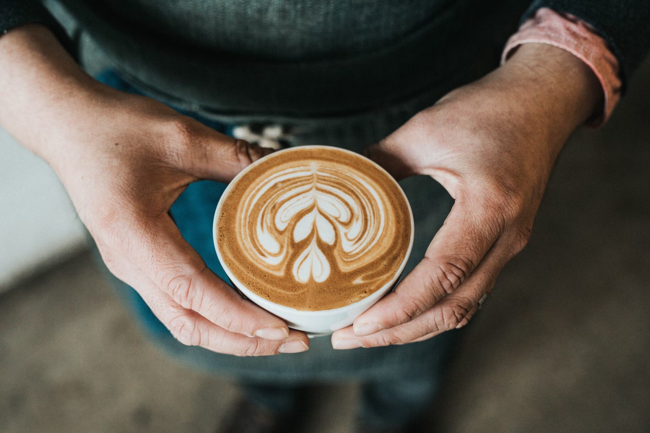 Person holding a coffee cup