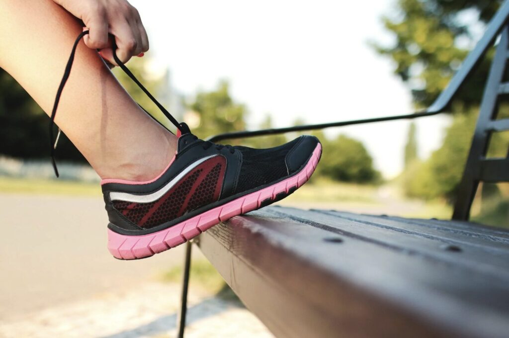 Person Tying Running Shoes